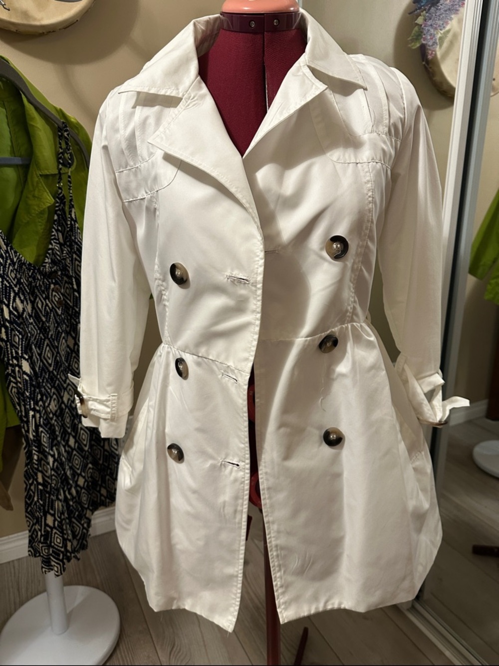 White midlength trench coat. Lightweight , button front with side pockets